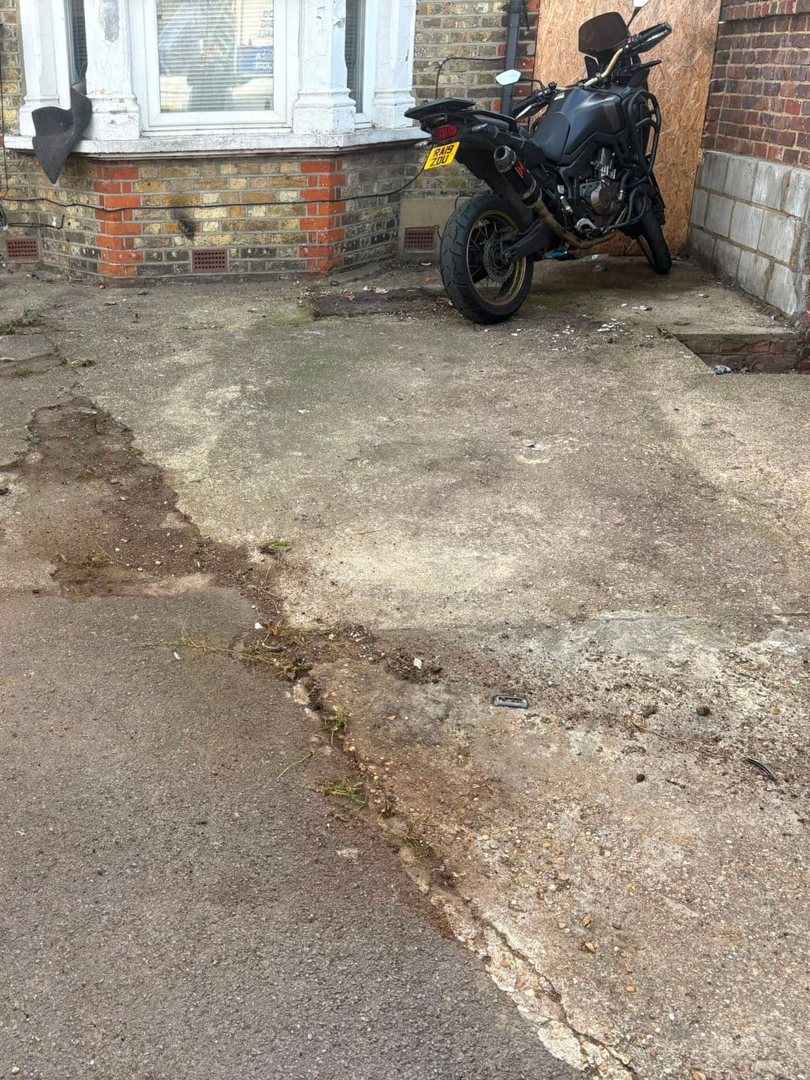 The same front drive after rubbish removal, with the mattress, wheelchair and suitcase cleared