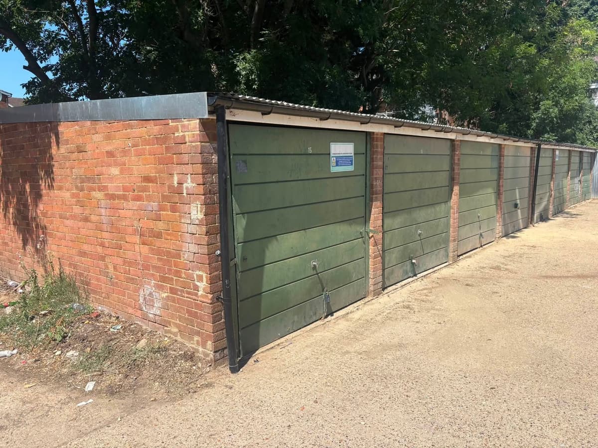 The same garage block after the rubbish was cleared, leaving the forecourt empty
