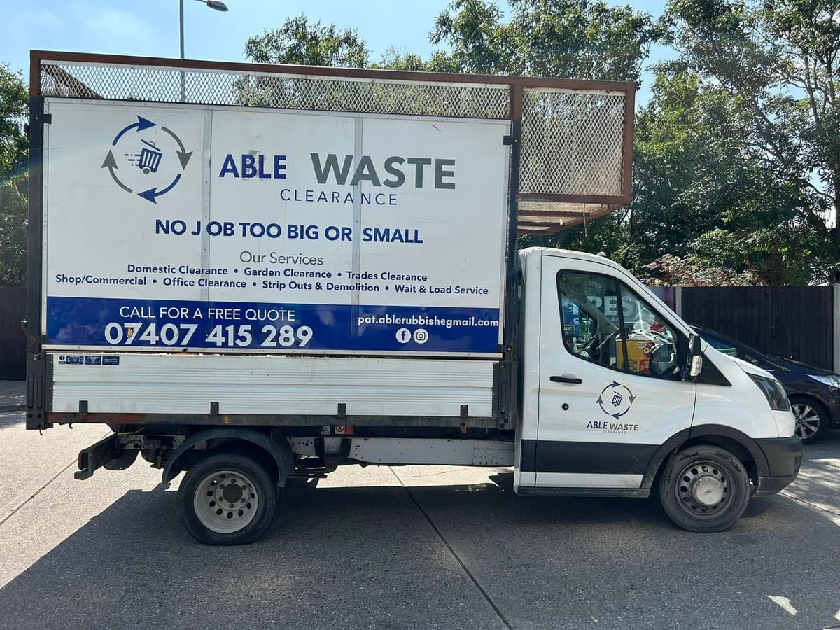 Able Rubbish and Gardening Services caged tipper van showing the services offered and the phone number 07407 415289